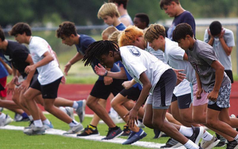 HUNTER KING | DISPATCH RECORD The younger boys group take off from the start line during their 110-yard sprints.