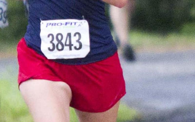 Holley Clifton of Lometa runs on the levee along Hancock Park Golf Course. Clifton placed second among female runners in the 5K race. JEFF LOWE | DISPATCH RECORD