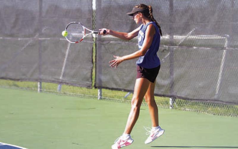 HUNTER KING | DISPATCH RECORD Chesley Breuer hits a forehand shot during her singles match.