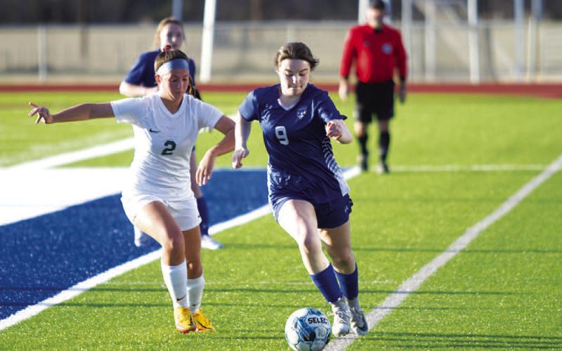 HUNTER KING | DISPATCH RECORD Bella Lindsey dribbles down the sideline against Academy. She scored four goals in the match.