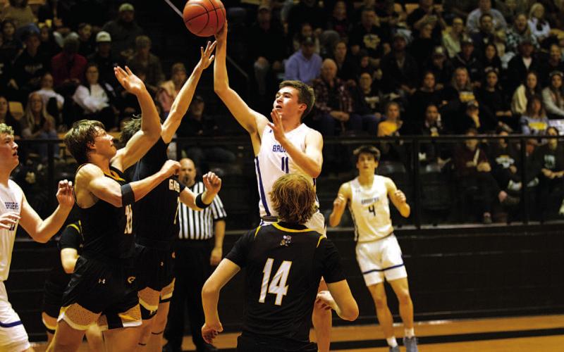 HUNTER KING | DISPATCH RECORD Jax Pratus attempts a floater in the paint against the Hornets.