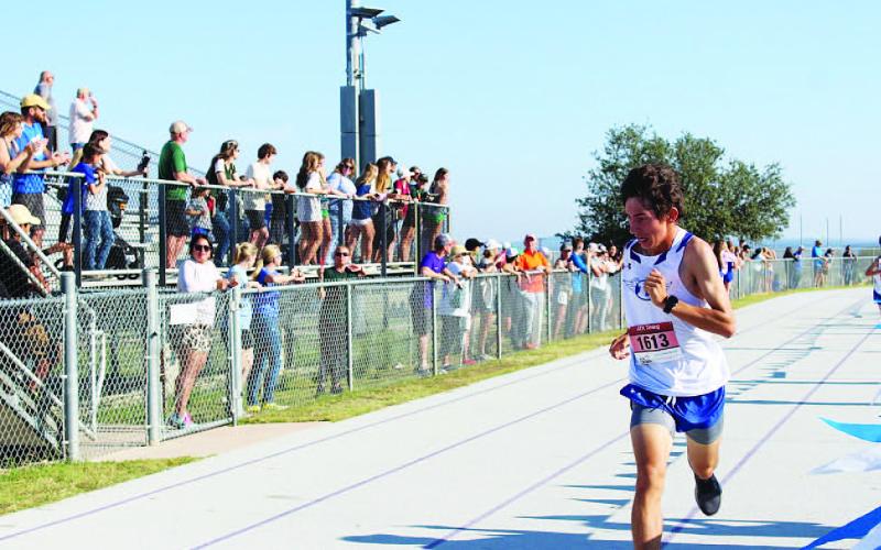 Clayton Shaw fights to finish the district race. He and the boys will run at regionals in Huntsville. COURTESY PHOTO