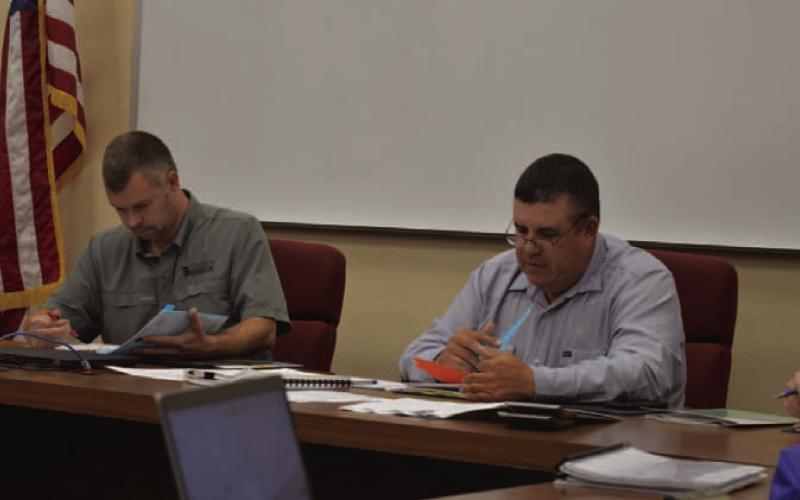 At left, Lampasas Central Appraisal District Board Chairman Marshal Brewer and Board Member Chris Harrison review the 2025 proposed budget amendments during Thursday’s meeting. ERICK MITCHELL | DISPATCH RECORD