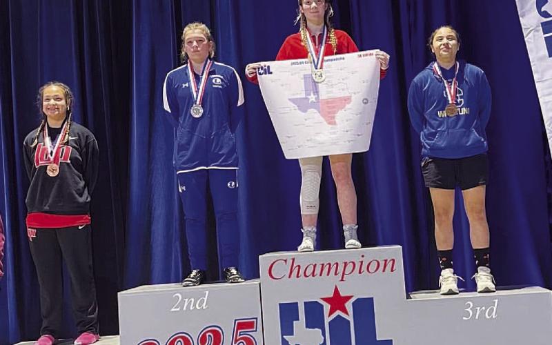 COURTESY PHOTO | DONOVAN KLECKNER Taylor Martell stands on the second-place spot of the podium at the state wrestling meet.