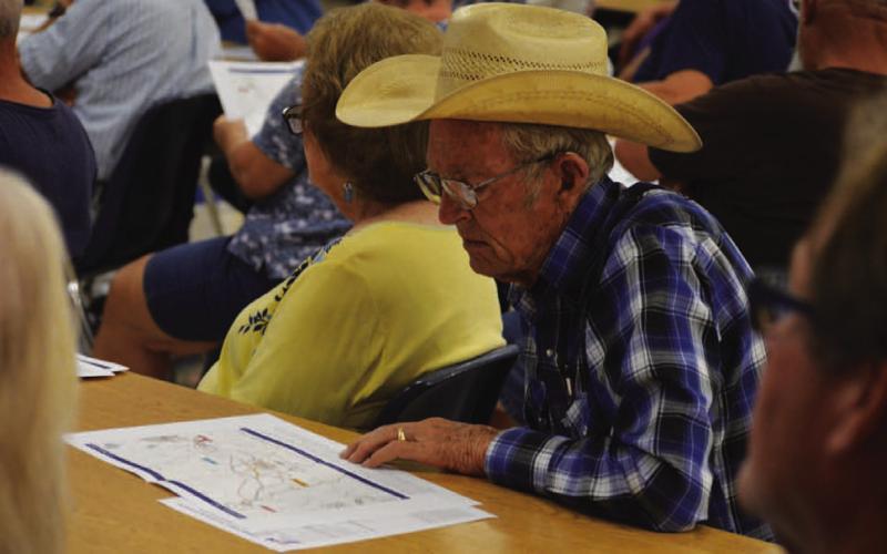 Lampasas County resident Ted Newsom studies route materials distributed at the Texas Department of Transportation meeting Monday on proposed Interstate Highway 14 expansion from Copperas Cove to Lometa.