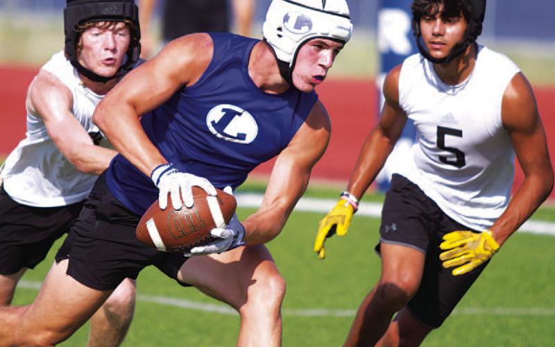 Jett Walker lunges toward the corner of the end zone during Tuesday’s 7-on-7 competition. HUNTER KING | DISPATCH RECORD