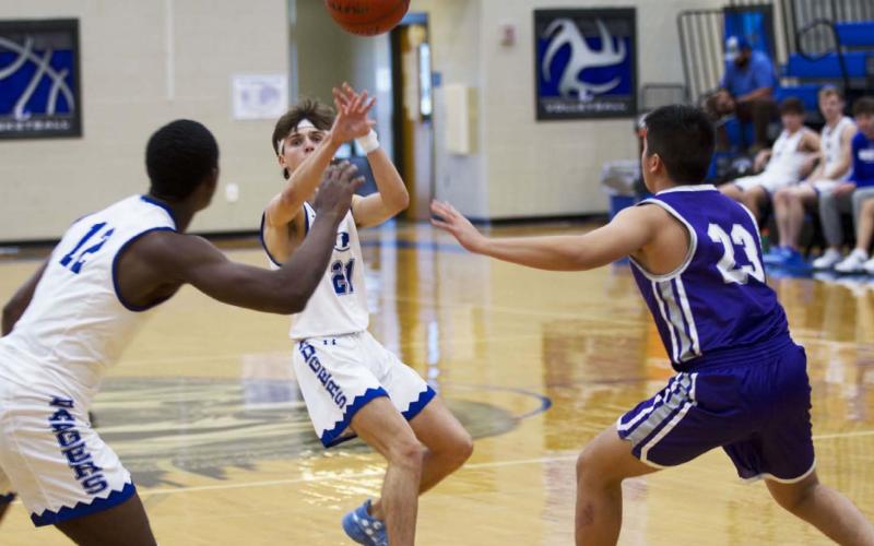 Austin Wilson lofts a pass to Johnki Gardner off a pick-and-roll, and Gardner went to the basket to finish last Monday. HUNTER KING | DISPATCH RECORD