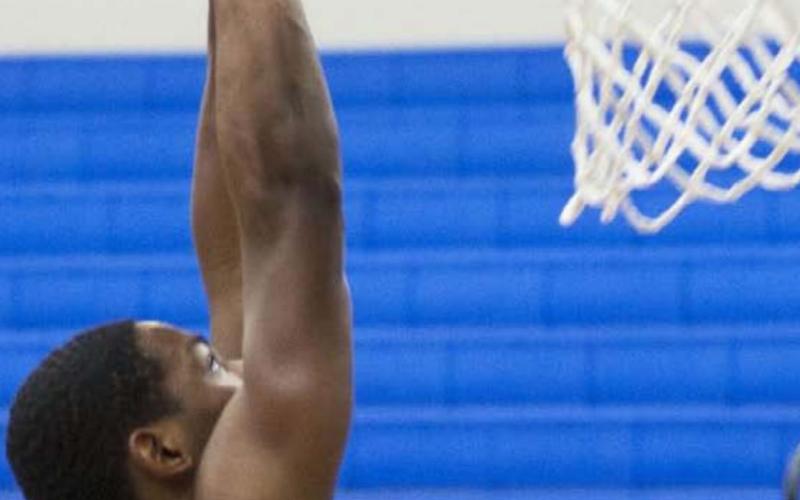 Johnki Gardner goes up to dunk the basketball to cap off his 23-point game against Austin Achieve. HUNTER KING | DISPATCH RECORD