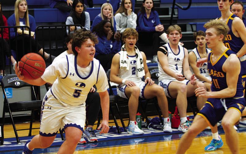 Aidan Nuckles dribbles past a Lago Vista defender. He scored 11 points in Tuesday’s game. HUNTER KING | DISPATCH RECORD
