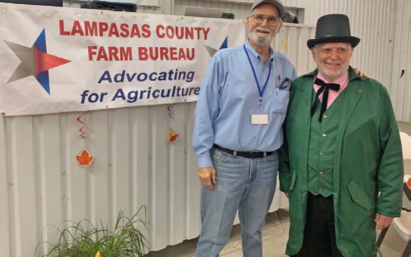 Lampasas County Farm Bureau Director and Public Relations Chairman Dr. Steve Forsythe, at left, greets the keynote speaker, Lampasas native Dr. Gary Moore of North Carolina, who dressed as the Wizard of Oz for his presentation at the county convention. COURTESY PHOTO