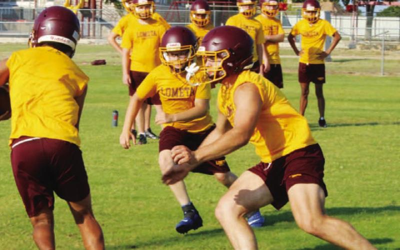 Josue Lopez runs the ball with Vance Weems, left, and Lukas Smailus-Cruz, right, in pursuit. MASON HINES | DISPATCH RECORD