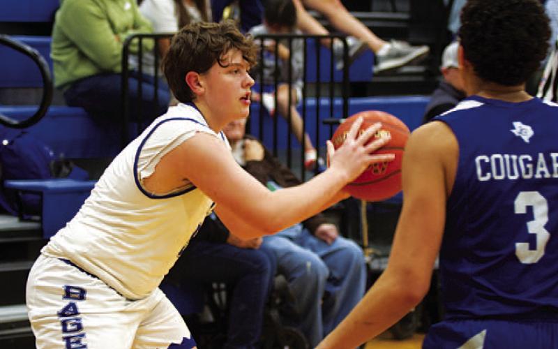 Aidan Nuckles looks for a teammate to pass to during the game. The freshman is deep into his first varsity season. HUNTER KING | DISPATCH RECORD