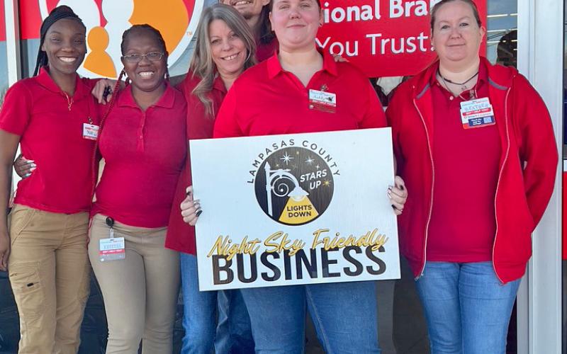 Employees, from left to right, Takira Green, Krystal Waters, Chris Wade, Connie C., Ashly Gilmore and Heather LaRue display the placard naming their store a Night Sky Friendly Business. courtesy photo