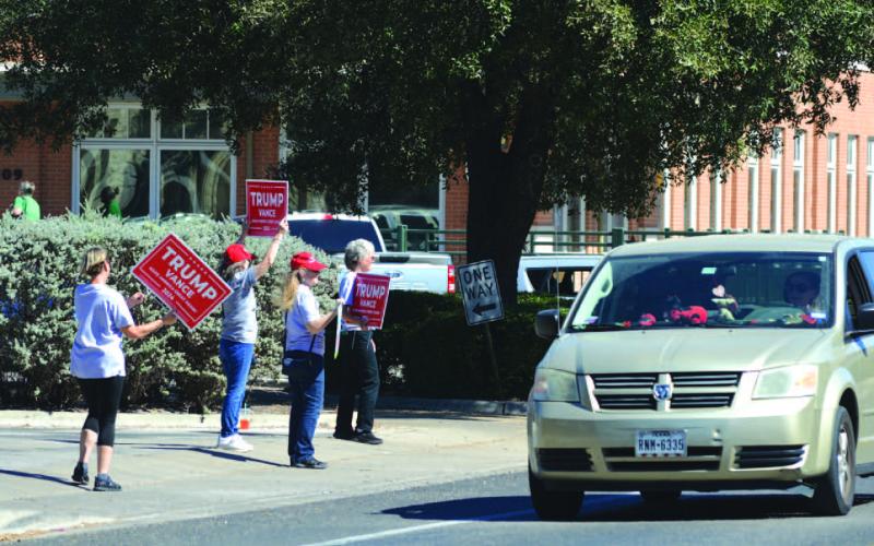 ERICK MITCHELL | DISPATCH RECORD Volunteers campaigned in downtown Lampasas this week for their favorite candidates and encouraged voter participation. Many East Fourth Street drivers honked in recognition of the push for early voting.
