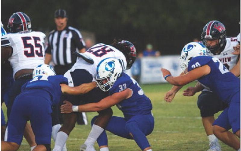 Levi Guthrie tackles the East View ball carrier. HUNTER KING | DISPATCH RECORD