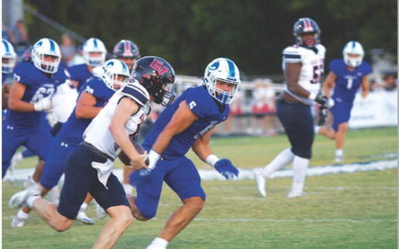 Raider Morua chases down quarterback Ty Blair early in last week’s game. HUNTER KING | DISPATCH RECORD