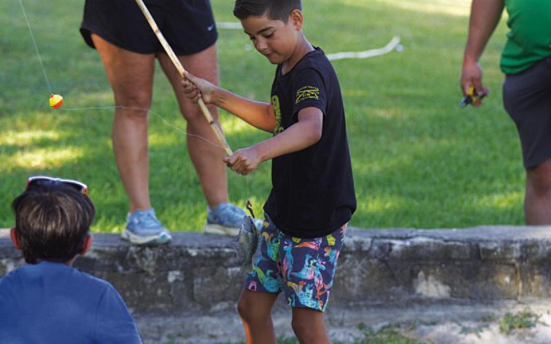 HUNTER KING | DISPATCH RECORD Liam Stokes holds the line after catching a perch.
