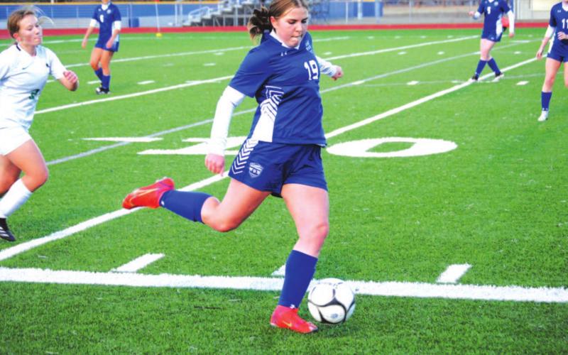 Ava Dowdy swings her leg to clear the ball from her own end in the Lady Badgers’ loss to Burnet. HUNTER KING | DISPATCH RECORD