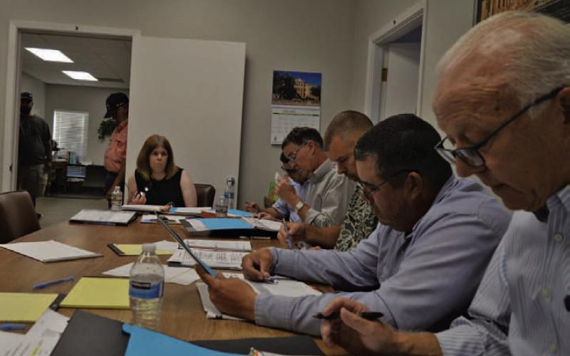 At back, Lampasas Central Appraisal District Chief Appraiser Susan Jones discusses budget matters Thursday evening alongside LCAD Board of Directors members. ERICK MITCHELL | DISPATCH RECORD