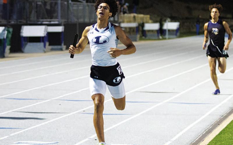 Ty Johnson crosses the finish line to win the 4x400-meter relay at the district track meet last week. HUNTER KING | DISPATCH RECORD
