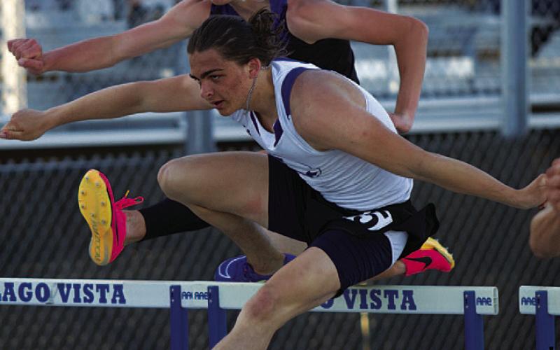 Asa White leaps over a hurdle during the 110-meter race. HUNTER KING | DISPATCH RECORD