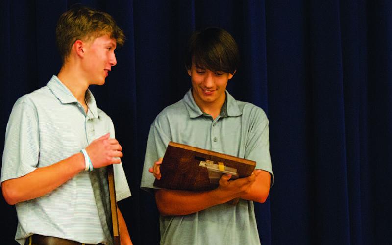 HUNTER KING | DISPATCH RECORD From left, Jonas Andersen and Calvin Phelps check out their team awards at the baseball banquet on Tuesday.