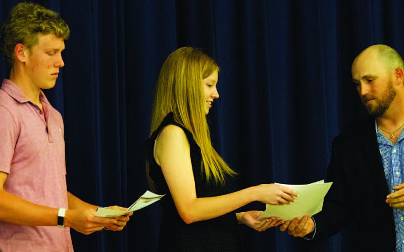 HUNTER KING | DISPATCH RECORD Preston Isom, left, and Reagan McDonald are given Academic All-State certificates from Evans.