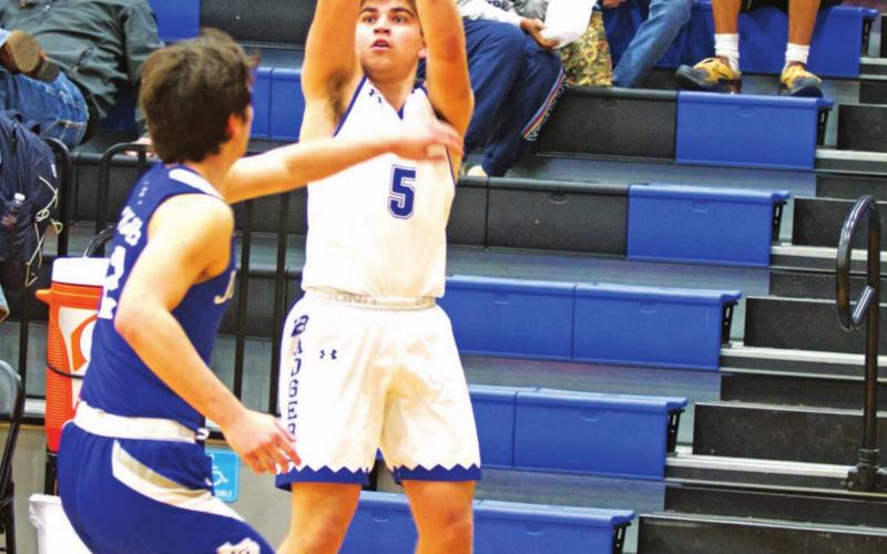 Dax Brookreson rises up over a Jarrell defender to make a three-point shot in Tuesday’s game. HUNTER KING | DISPATCH RECORD