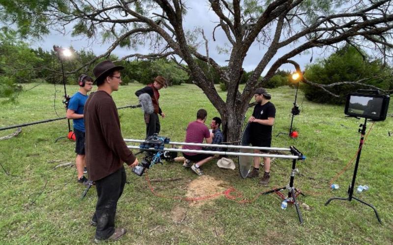 A film crew based out of Des Moines, Iowa gathers around a tree on the Crain/VanNatta-8-Ranch in Lampasas County while working on its production of “Big Iron.” COURTESY PHOTO