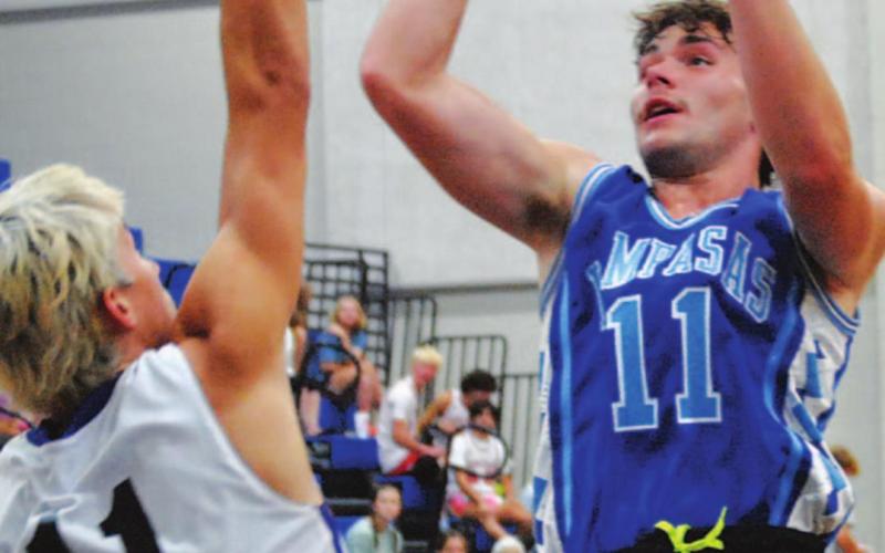 Carter Johnson goes over a defender during summer league. HUNTER KING | DISPATCH RECORD