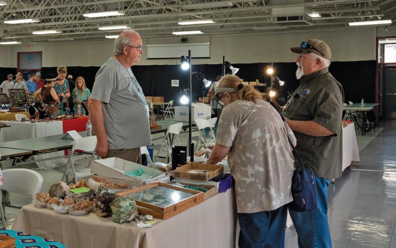 Indian Artifact &amp;amp; Mineral and Gem Show attendees chat with a vendor during last Saturday’s event. Adam Barrios| Dispatch Record