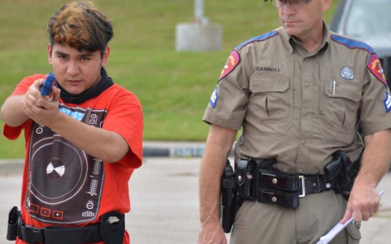 Texas Department of Public Safety Cpl. Monte Carroll judges Lampasas High School sophomore Edward Chandler’s capabilities in conducting a felony traffic stop. MONIQUE BRAND | DISPATCH RECORD