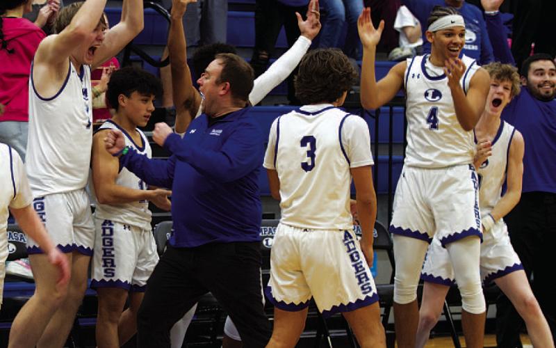 HUNTER KING | DISPATCH RECORD Head coach Aaron Nuckles and his team erupt in celebration as the final seconds ticked off the clock.