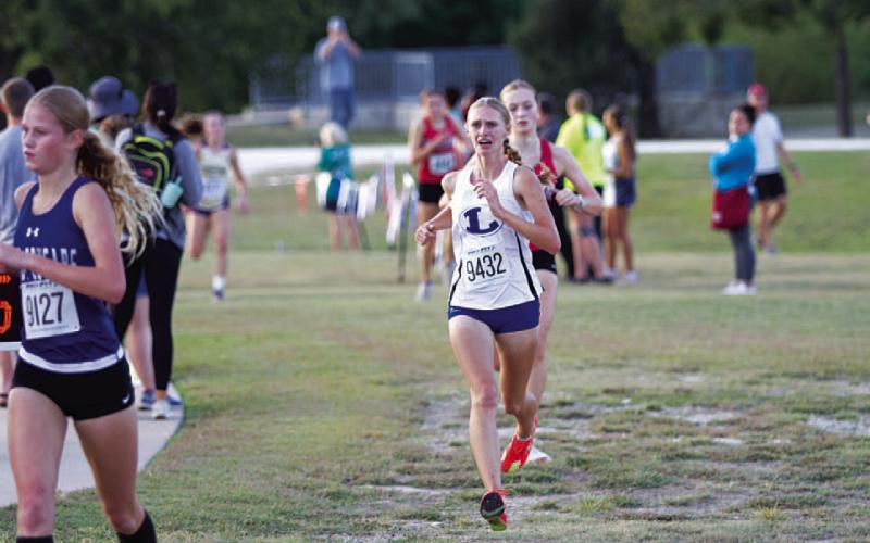 Leah Phillips shows emotion as she approaches the finish line at the district meet. HUNTER KING | DISPATCH RECORD