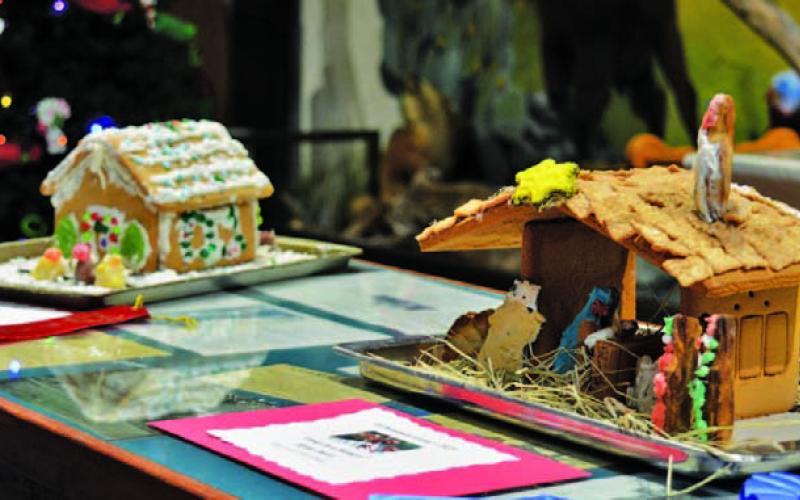 At right, the “Away in a Manger” gingerbread house created by Kylee Davis earned first place in the 8- to 12-year-olds division, while the “Carolers” house to the left made by Gwendolyn Martin earned second. ERICK MITCHELL | DISPATCH RECORD