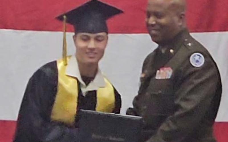 John W. Harvey III graduated in December from the Texas Challenge Academy, a residential military program sponsored by the Texas National Guard. He is pictured with the commencement speaker, who presented his diploma. courtesy photo