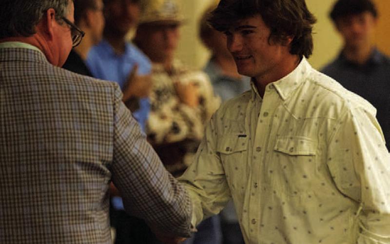 Tate Langford shakes Rogers’ hand while getting his award. HUNTER KING | DISPATCH RECORD Corbin Kepler received the Linebacker award last week.