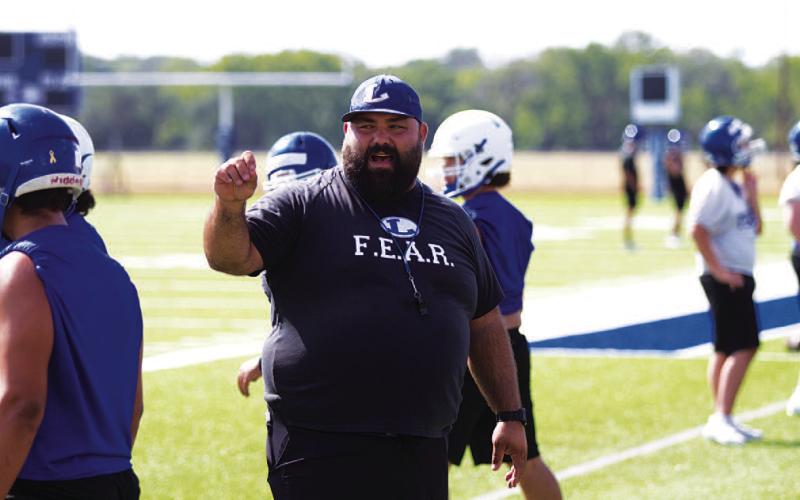 Offensive Coordinator TJ Cleavinger works with the offensive line. HUNTER KING | DISPATCH RECORD