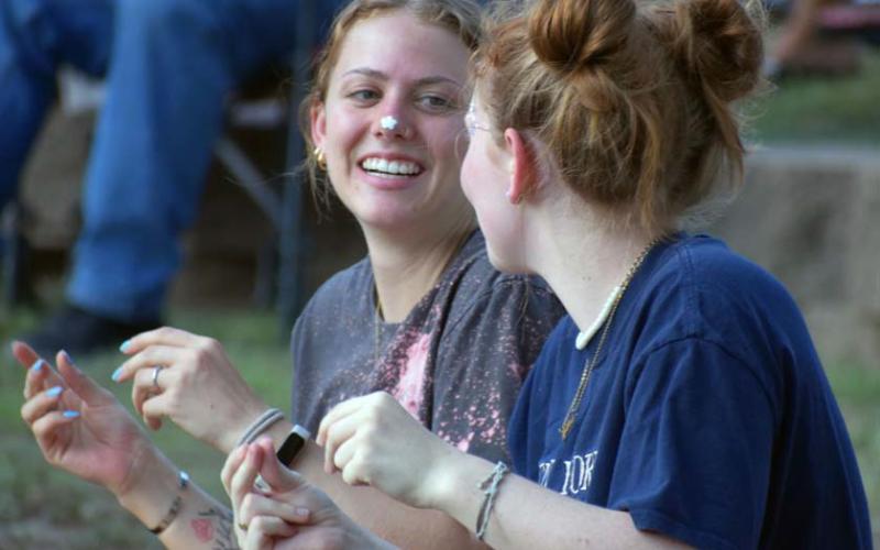 Lydia Skiles and Lyla Skiles snap along to the music at the annual Spring Ho Festival Gospel Night. JOSEPH NEUENSCHWANDER | LAMPASAS