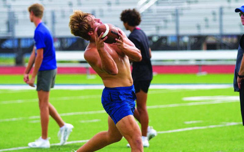 HUNTER KING | DISPATCH RECORD Haegan Oncken hauls in a pass during the hour of sport-specific workouts following SWAT on Wednesday morning.