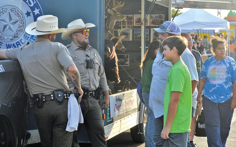Lampasas residents stop by for a chat at the Texas Game Warden booth at last year’s National Night Out event. file photo