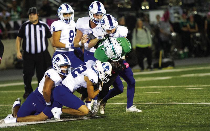 Jackson Wright (22) and Sean Smith make a tackle on the Burnet ball carrier. HUNTER KING | DISPATCH RECORD