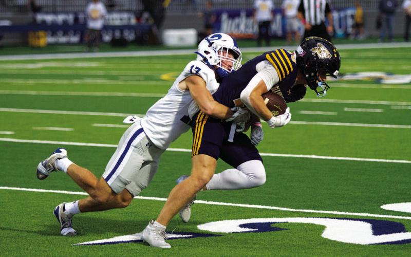 HUNTER KING | DISPATCH RECORD Sean Smith wraps up a Stephenville receiver after a short gain.