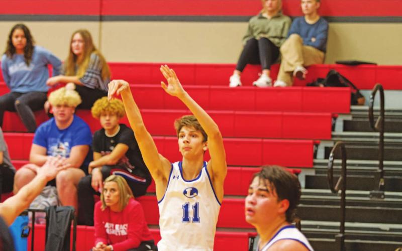 Luke Shivers releases a three-point shot in the Badgers’ game against Bastrop. HUNTER KING | DISPATCH RECORD