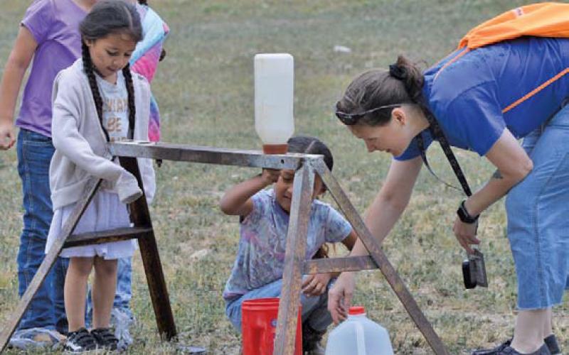 Hanna Springs kindergartner Amari Knight learns the basics of milking during Ag Safety Day. ERICK MITCHELL | DISPATCH RECORD