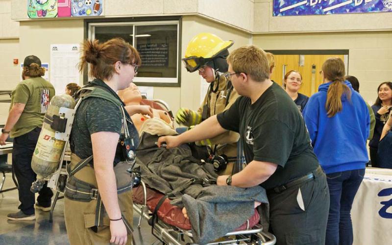 Wren Garner, Joseph Walden and Tony Carey demonstrate the tools and equipment available in Lampasas High School’s Emergency Services class. Adam Barrios | dispatch record