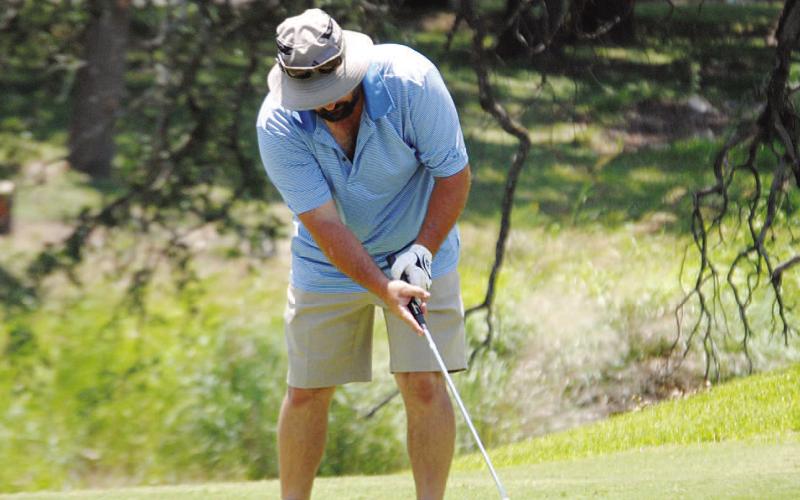 HUNTER KING | DISPATCH RECORD Gerry Spore hits a putt on the fifth green at Hancock Park Golf Course, home of the A.C. January Memorial Tournament.