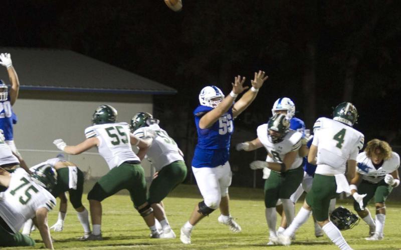Connor Keele jumps and puts his hands up to try and block a kick attempt by Canyon Lake in last Friday’s game. HUNTER KING | DISPATCH RECORD