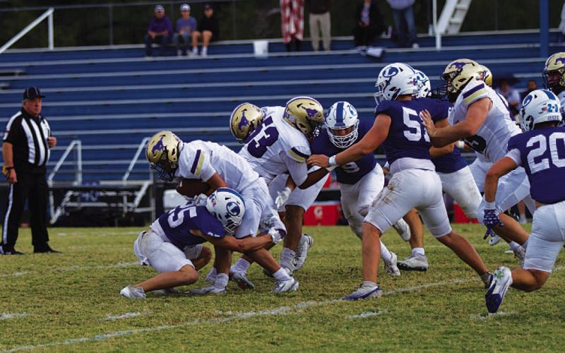 Jonathan Bowling wraps up the Marble Falls ballcarrier during last Saturday’s game. HUNTER KING | DISPATCH RECORD