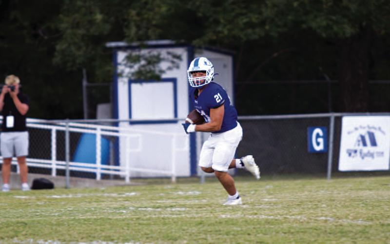 KJ Reed breaks off a big run to open the game. HUNTER KING | DISPATCH RECORD